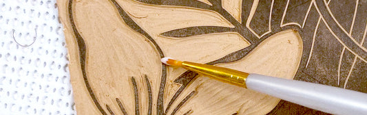 Fixing carving mistakes in linocut printmaking. Showing a carved linocut block and how to fixe it, gluing a small part of linoleum to fix a carving mistake. Art by Booba Prints