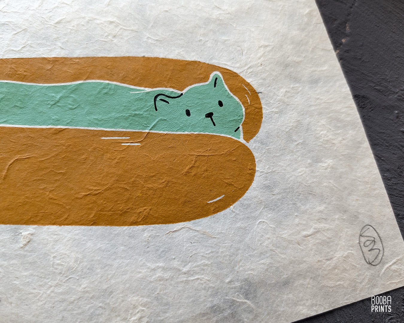 Original 2 color linocut print, printed in Ochre and mint green, showing a cute cat in a hot dog but. Cute whimsical art for your kitchen. Art by Booba Prints