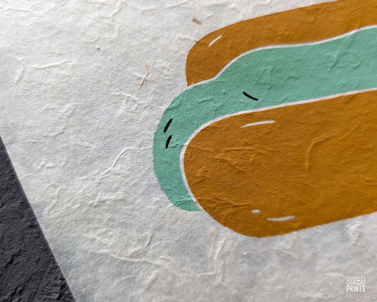 Original 2 color linocut print, printed in Ochre and mint green, showing a cute cat in a hot dog but. Cute whimsical art for your kitchen. Art by Booba Prints
