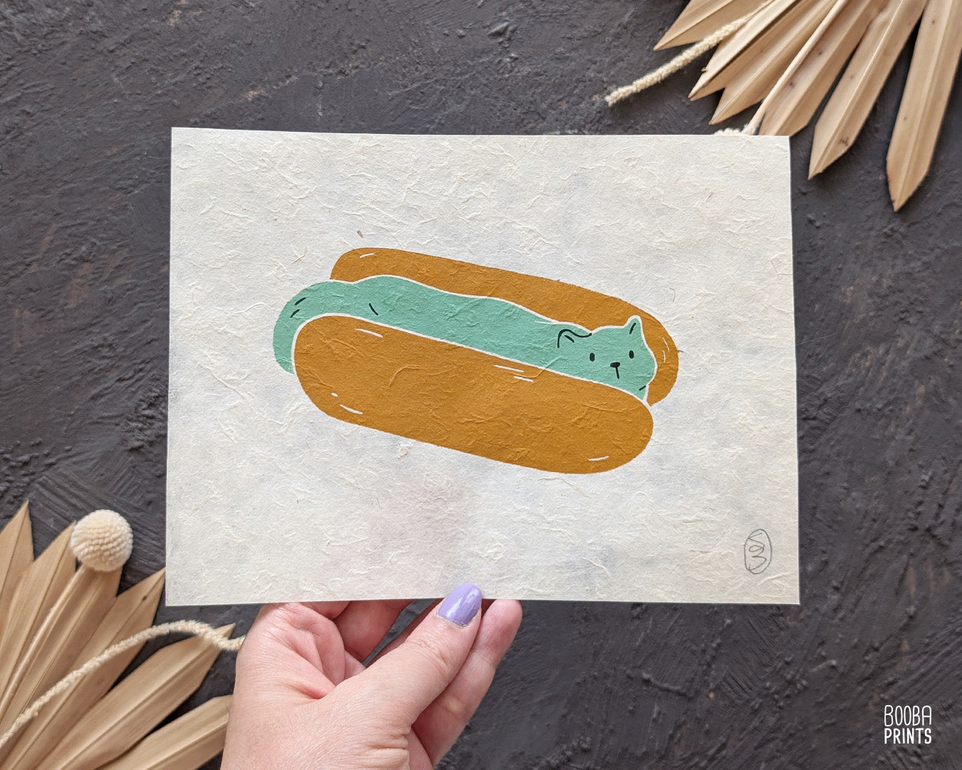 Original 2 color linocut print, printed in Ochre and mint green, showing a cute cat in a hot dog but. Cute whimsical art for your kitchen. Art by Booba Prints