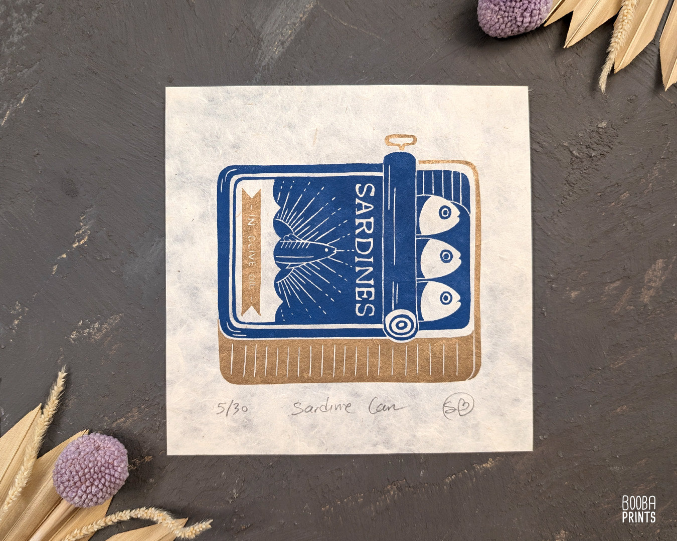 Original handmade linocut prints of Sardine Tin Can. Printed in blue and gold, using oil based ink on natural Lokta paper. Cute print for kitchen, stylized sardine print. Art by Booba Prints.