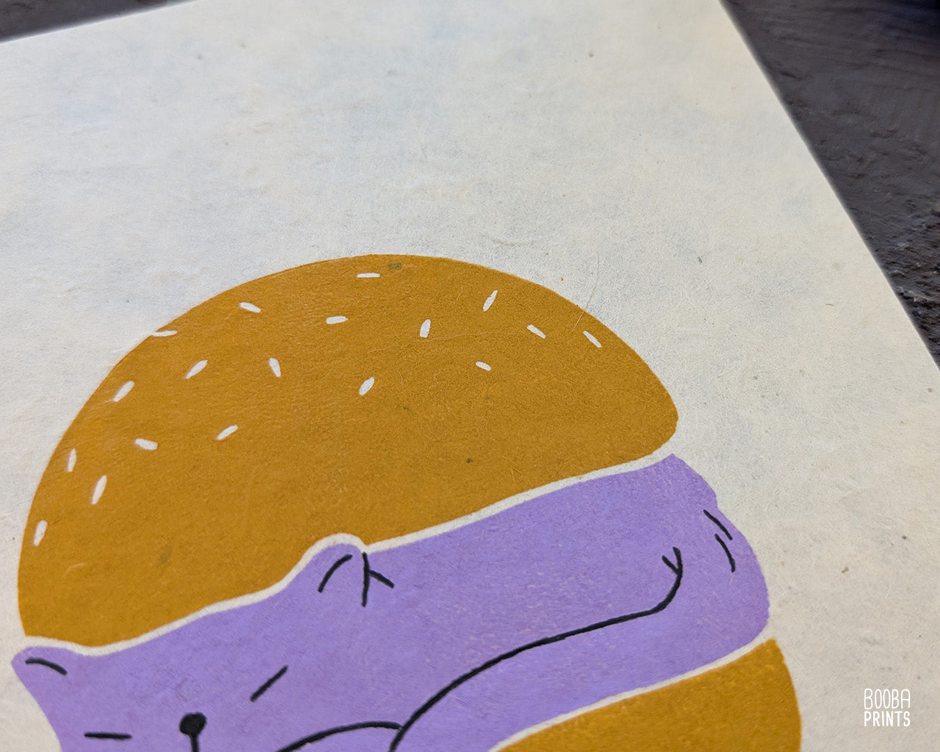Original handmade linocut print of "Burger Cat" featuring a cute cat between 2 burger buns. Printed in 2 colors: lavender and yellow ochre. Original linocut print in he size of 6"x8". Art by Booba Prints