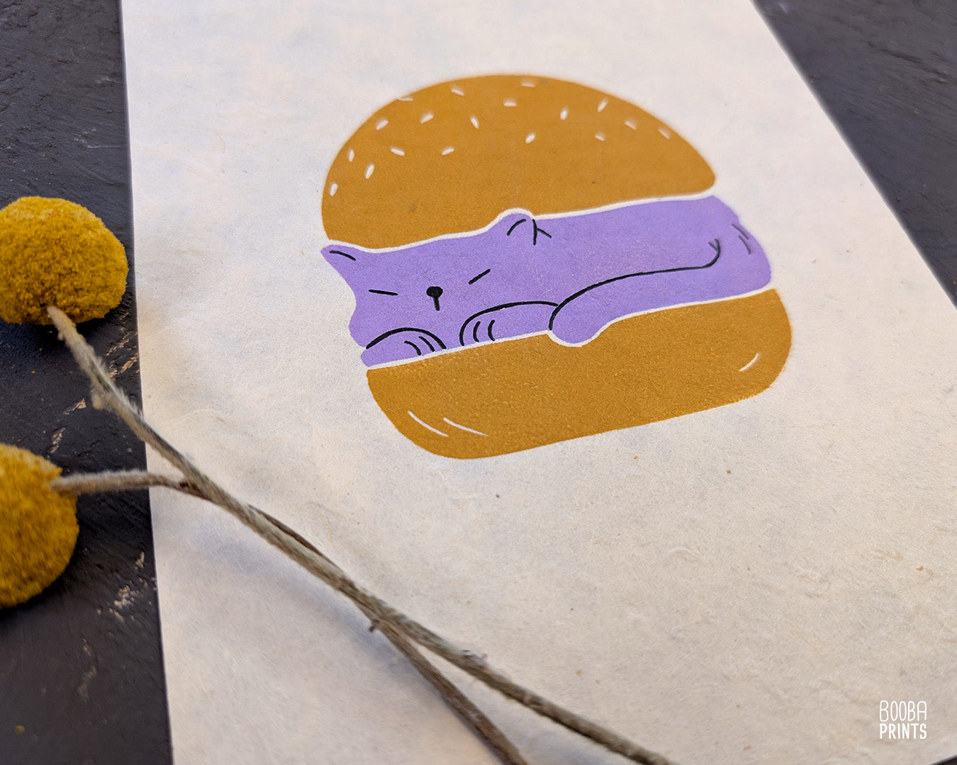 Original handmade linocut print of "Burger Cat" featuring a cute cat between 2 burger buns. Printed in 2 colors: lavender and yellow ochre. Original linocut print in he size of 6"x8". Art by Booba Prints