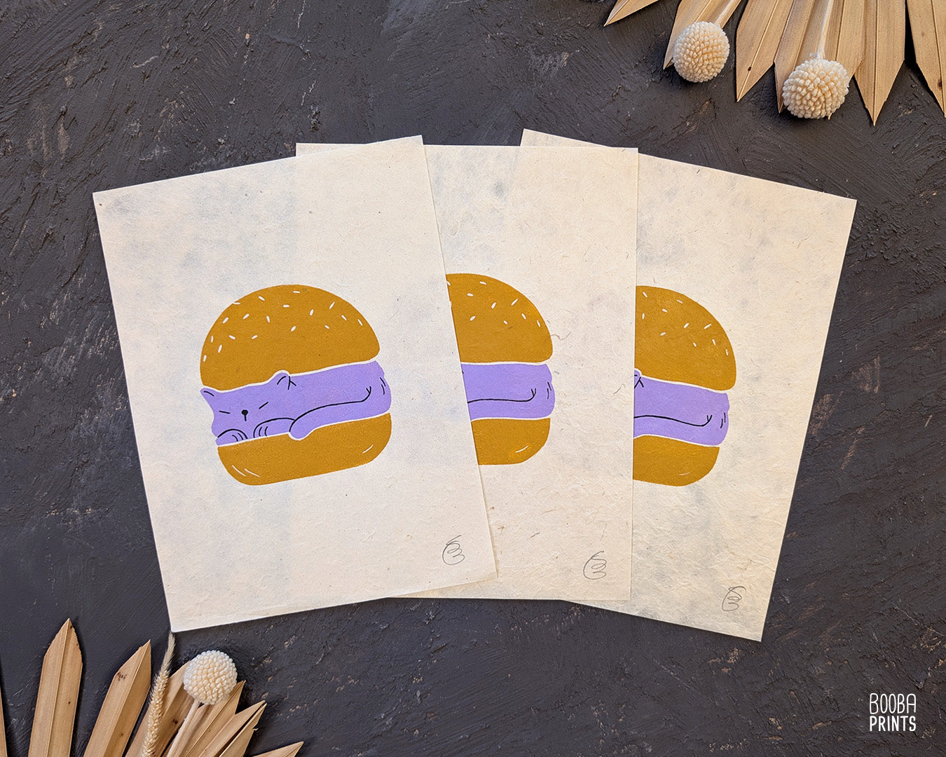 Original handmade linocut print of "Burger Cat" featuring a cute cat between 2 burger buns. Printed in 2 colors: lavender and yellow ochre. Original linocut print in he size of 6"x8". Art by Booba Prints