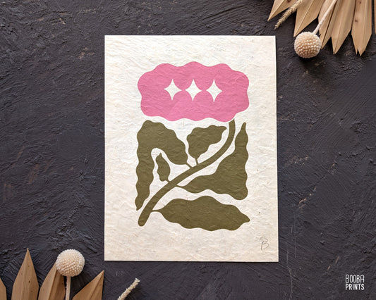Minimalist mini linocut print of a hand carved flower, printed in soft green and pink ink on white paper, handmade botanical wall art. Cozy house warming gift. Art by Booba Prints
