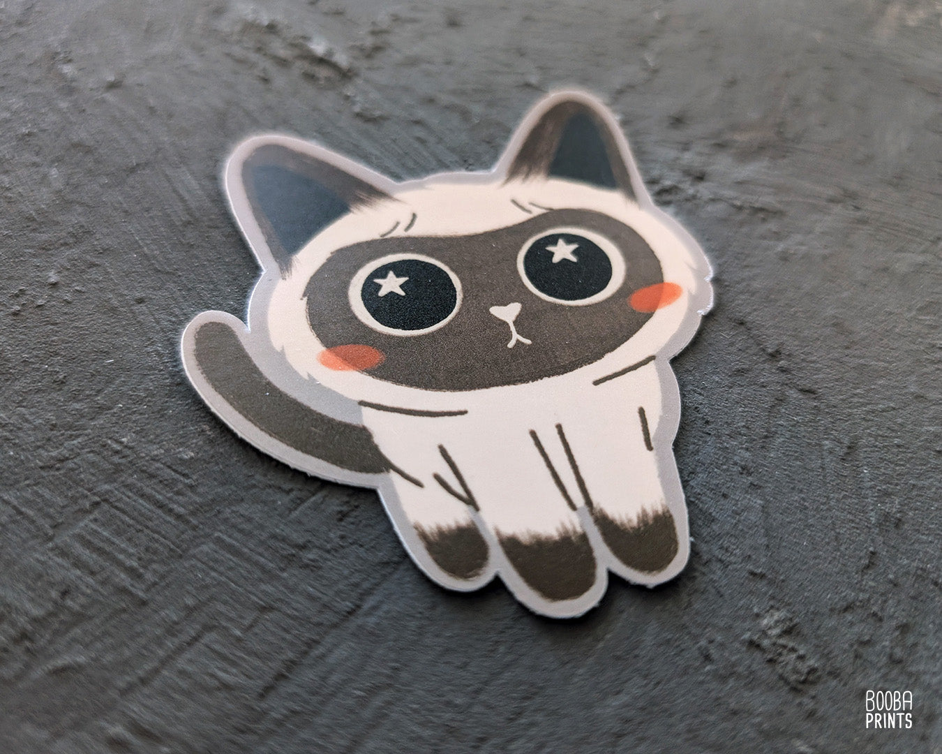A cute stylized Siamese cat sticker against a grey background. Adorable sticker for cat lovers. Waterproof vinyl sticker for planner, bottle, laptop.