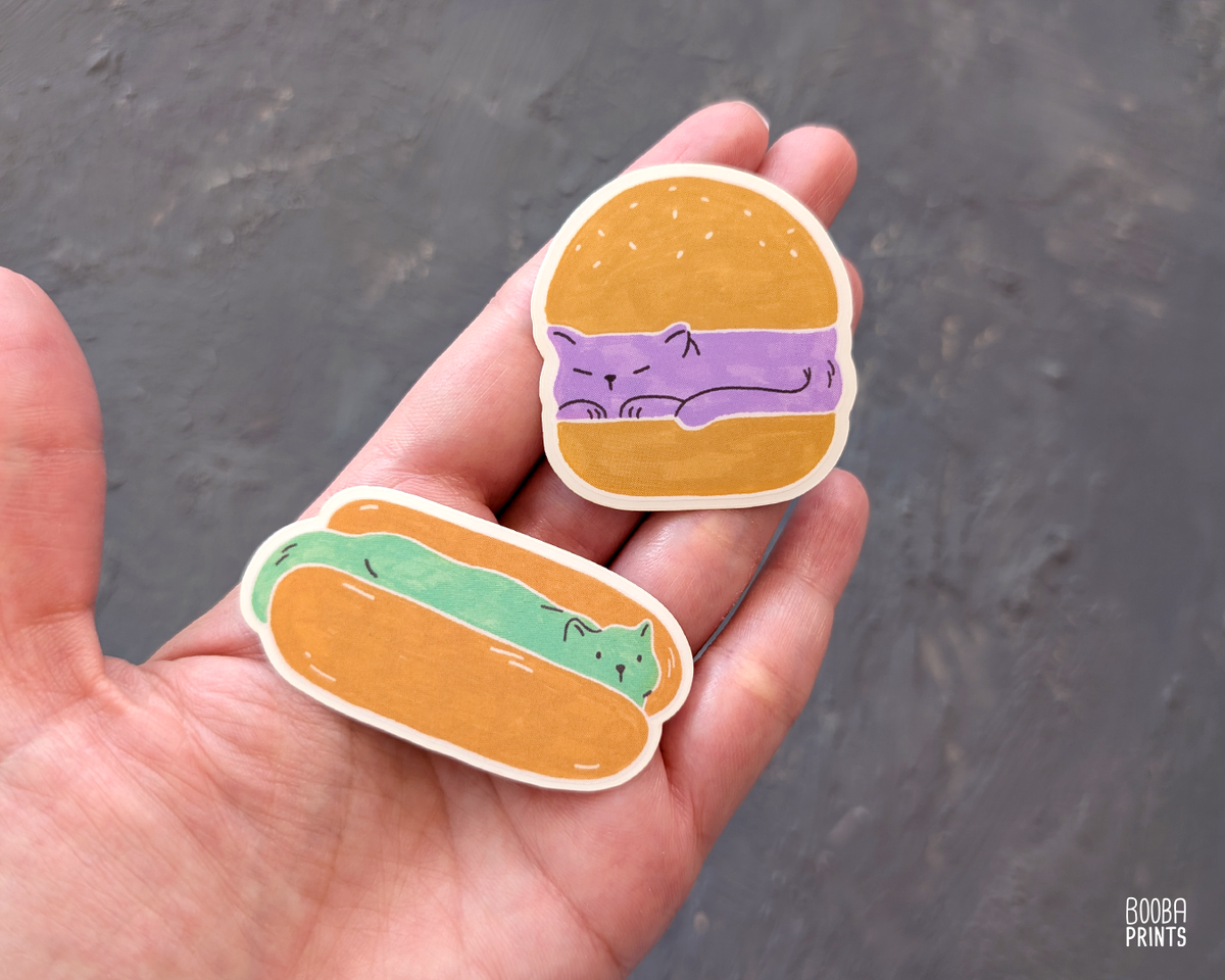 Original 2 color linocut print, printed in Ochre and mint green, showing a cute cat in a hot dog but. Cute whimsical art for your kitchen. Art by Booba Prints. Check out 2 vinyl sticker of the same series: Burger Cat and Hot Dog Cat