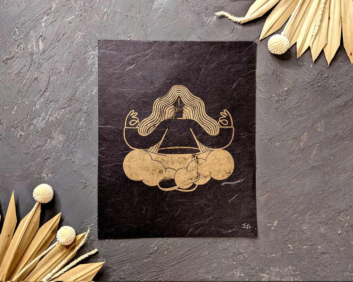 Handmade linocut print of Golden Meditation. stylized illustration of a woman sitting in meditation pose. Super Seconds Festival, sale of samples and seconds, art by Booba Prints