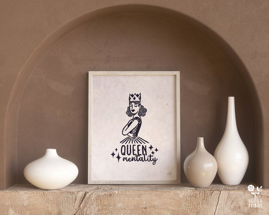 Handmade linocut print of Queen Mentality. Stylized illustration of a queen hugging herself and the text queen mentality. Printed with black or gold oil based ink on natural or Hosho paper. Empowering print for home decor. Super Seconds Festival, sale of samples and seconds. Artwork by Booba Prints.