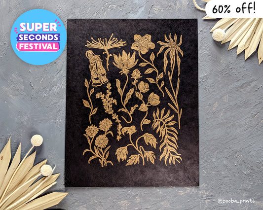 Handmade linocut print of #2 Golden Flowers. stylized flowers illustration, printed with oil based ink on black paper. Super Seconds Festival, sale of samples and seconds. Art by Booba Prints.