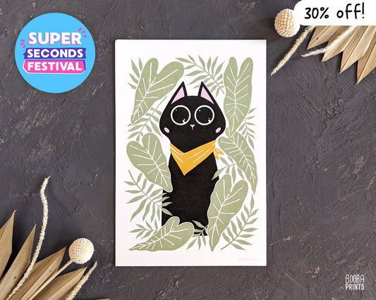 Digitally printed art print of Bandana Cat. Black cat wearing yellow bandana and surrounded by green leaves. Cute cat illustration for cat lover. Super Seconds Festival, an online market and sale of samples and seconds in a reduced price. This print is part of Super Seconds Festival and it's 30% off. Art by Booba Prints