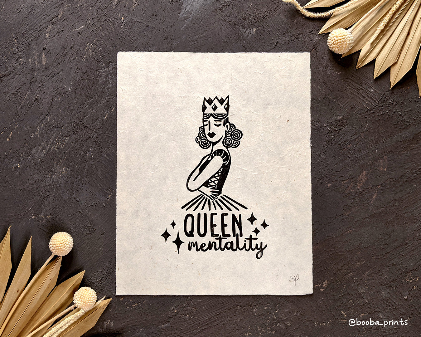Handmade linocut print of Queen Mentality. Stylized illustration of a queen hugging herself and the text queen mentality. Printed with black or gold oil based ink on natural or Hosho paper. Empowering print for home decor. Super Seconds Festival, sale of samples and seconds. Artwork by Booba Prints.