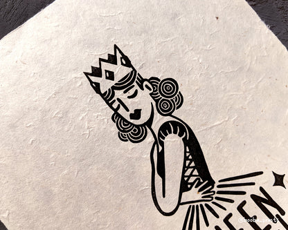 Handmade linocut print of Queen Mentality. Stylized illustration of a queen hugging herself and the text queen mentality. Printed with black or gold oil based ink on natural or Hosho paper. Empowering print for home decor. Super Seconds Festival, sale of samples and seconds. Artwork by Booba Prints.