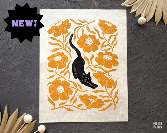 Handmade original linocut print of Stretchy Cat, a black cat and orange flower linocut print. Gift for cat lover or a flower lover. Housewarming gift. Mother's Day gift. Artwork for home decor. Gallery wall print. Art by Booba Prints