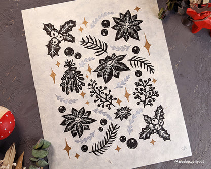 Handmade original linocut Christmas floral print. 3 color print in black, metallic silver and metallic gold in the spirit of Christmas. Christmas flowers Poinsettia, Holly and Mistletoe. Printed with oil based ink on natural Lokta paper. 11x14 inches. Decoration for holiday season. ready to be framed art by Booba Prints. Super Seconds Festival, sale of samples and seconds, discounted prints for online sale.