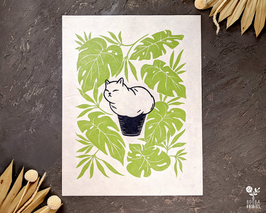 Handmade and handprinted linocut print of Muffin cat, cat shaped like a muffin, surrounded by Monstera Deliciosa leaves. 2 color original art in black and green to add to your walls and home decor. Cat lover print, plant lover print. Art by Booba Prints